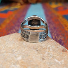 Lapis Oval Ring by Raymond Coriz featuring a large oval blue lapis stone set in Sterling Silver with a split band and intricate stamped detailing; underside view.