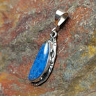 Sterling silver pendant with lapis set in the bezels and incised framing.