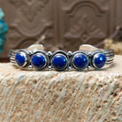 Sterling silver cuff bracelet with lapis set in a quintet of round bezels, framed by twisted rope and dotted accents.