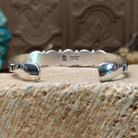Sterling silver cuff bracelet with lapis set in a quintet of round bezels, framed by twisted rope and dotted accents.