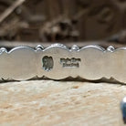 Close-up of the artisan's stamped signature.