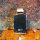 Close-up of the artisan's stamped signature.