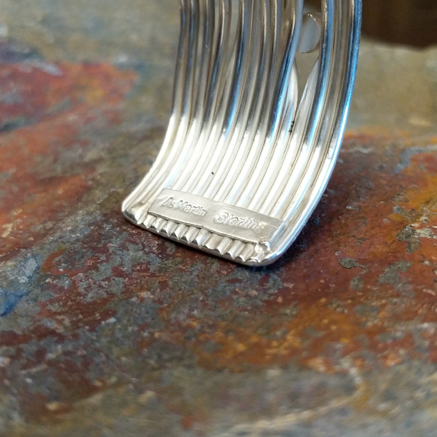 Close-up of the artisan's stamped signature.