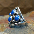 Sterling silver ring with lapis set in tetrad bezels along the surface and dotted accents.