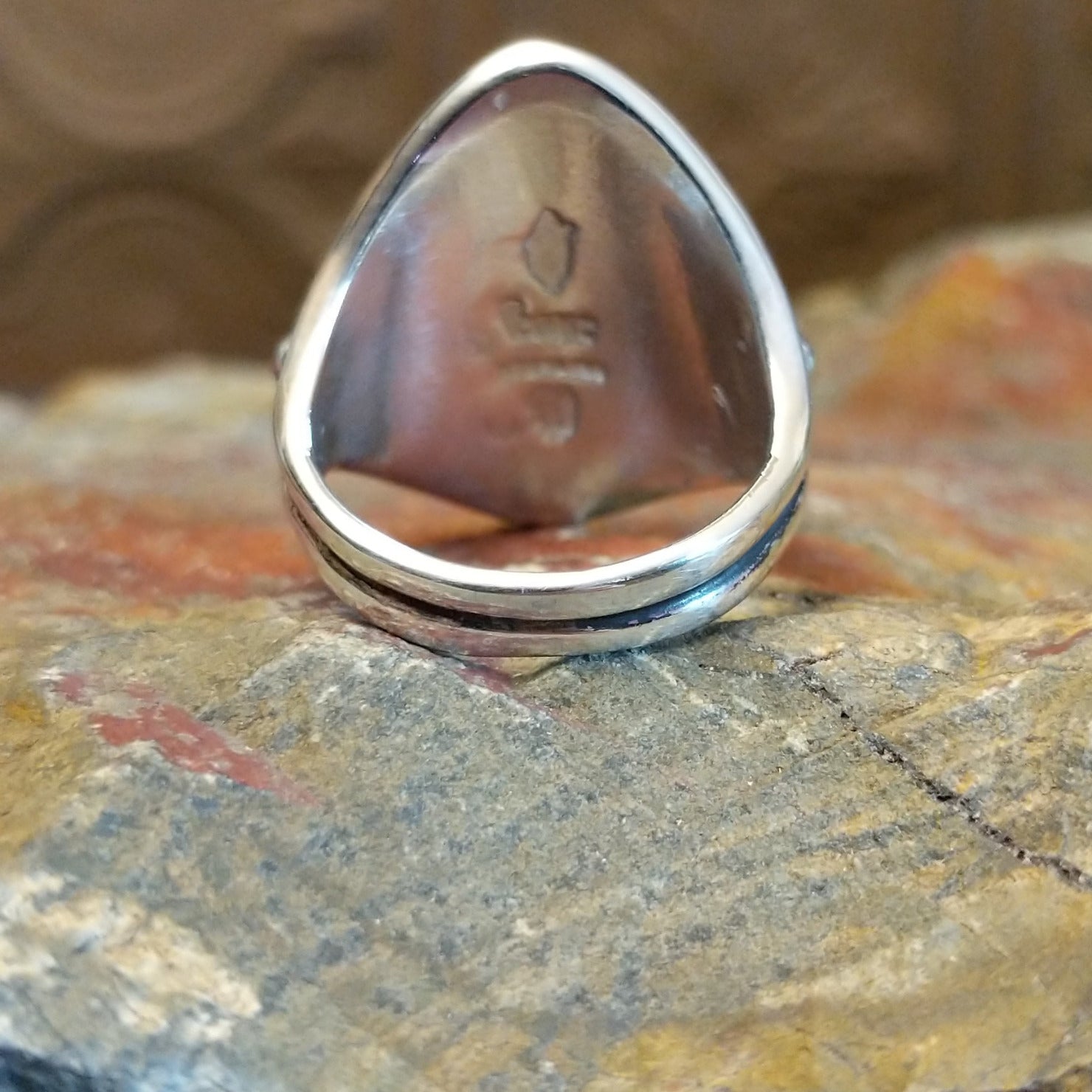 Sterling silver ring with lapis set in tetrad bezels along the surface and dotted accents.