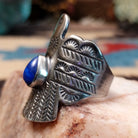 Sterling silver thunderbird ring featuring lapis in a teardrop bezel.
