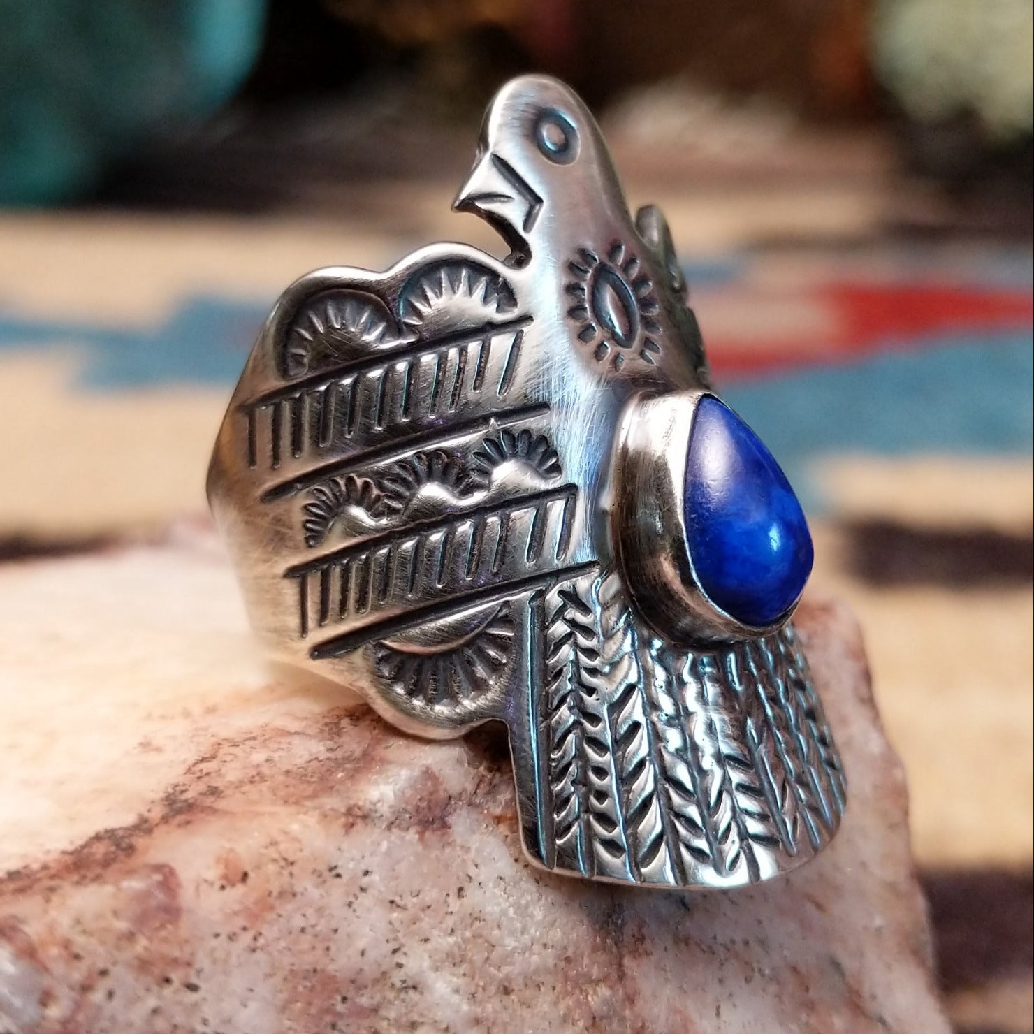 Sterling silver thunderbird ring featuring lapis in a teardrop bezel.