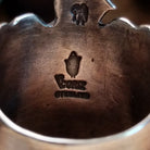Close-up of the artist's stamped signature.
