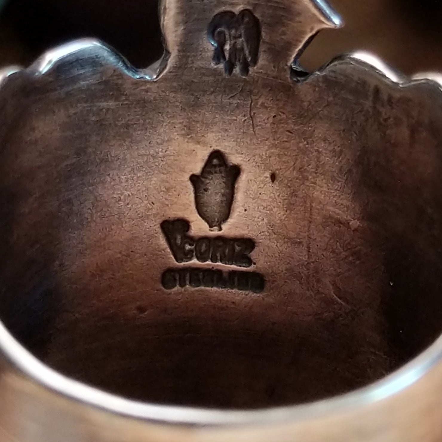 Close-up of the artist's stamped signature.