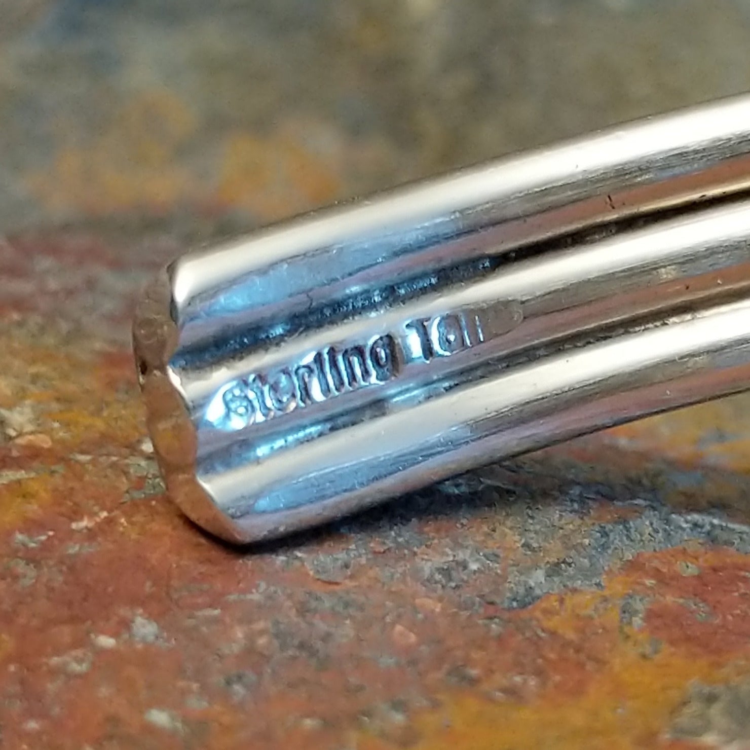 Close-up of the artisan's stamped signature.