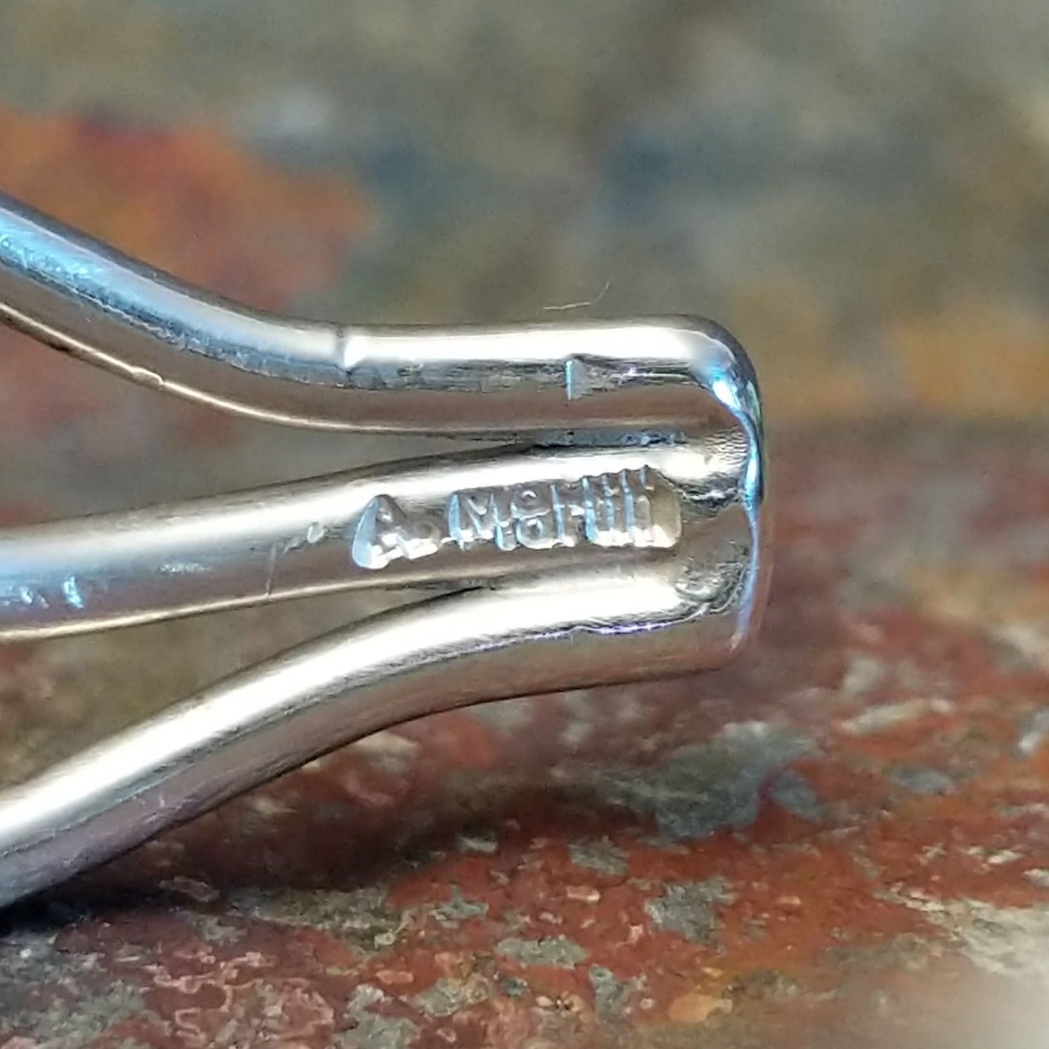 Close-up of the artisan's stamped signature.