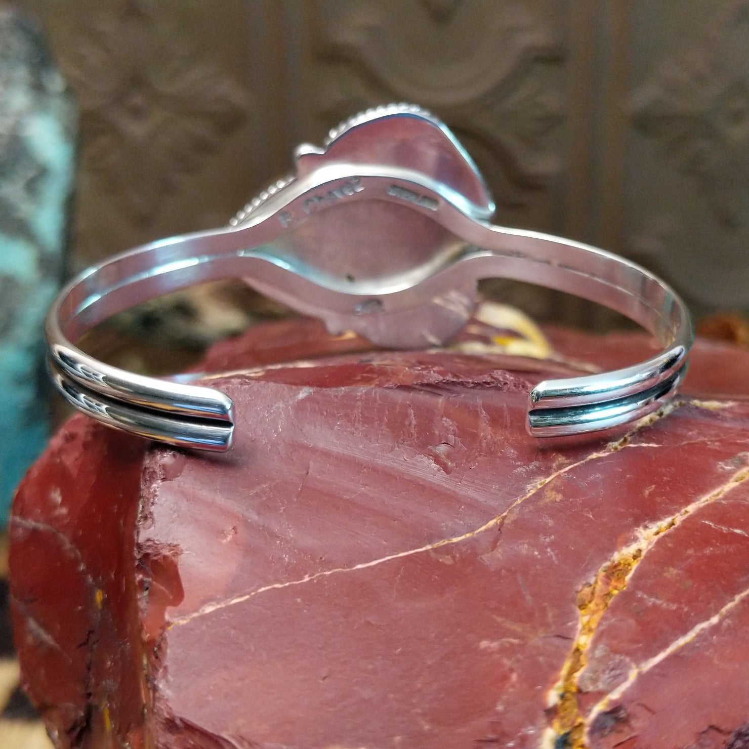 Sterling silver cuff bracelet with lapis set in a triad of bezels, framed by twisted rope accents.