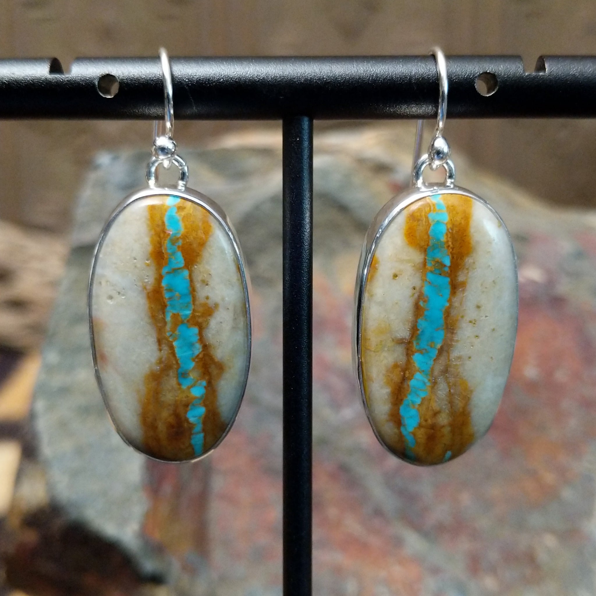 Handcrafted sterling silver large Boulder Turquoise oval earrings by Lowell Draper, featuring natural Boulder Turquoise gemstones in classic bezel settings.