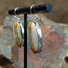 Handcrafted sterling silver large Boulder Turquoise oval earrings by Lowell Draper, featuring natural Boulder Turquoise gemstones in classic bezel settings; side view.