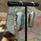 Handcrafted sterling silver large Boulder Turquoise oval earrings by Lowell Draper, featuring natural Boulder Turquoise gemstones in classic bezel settings; side view.