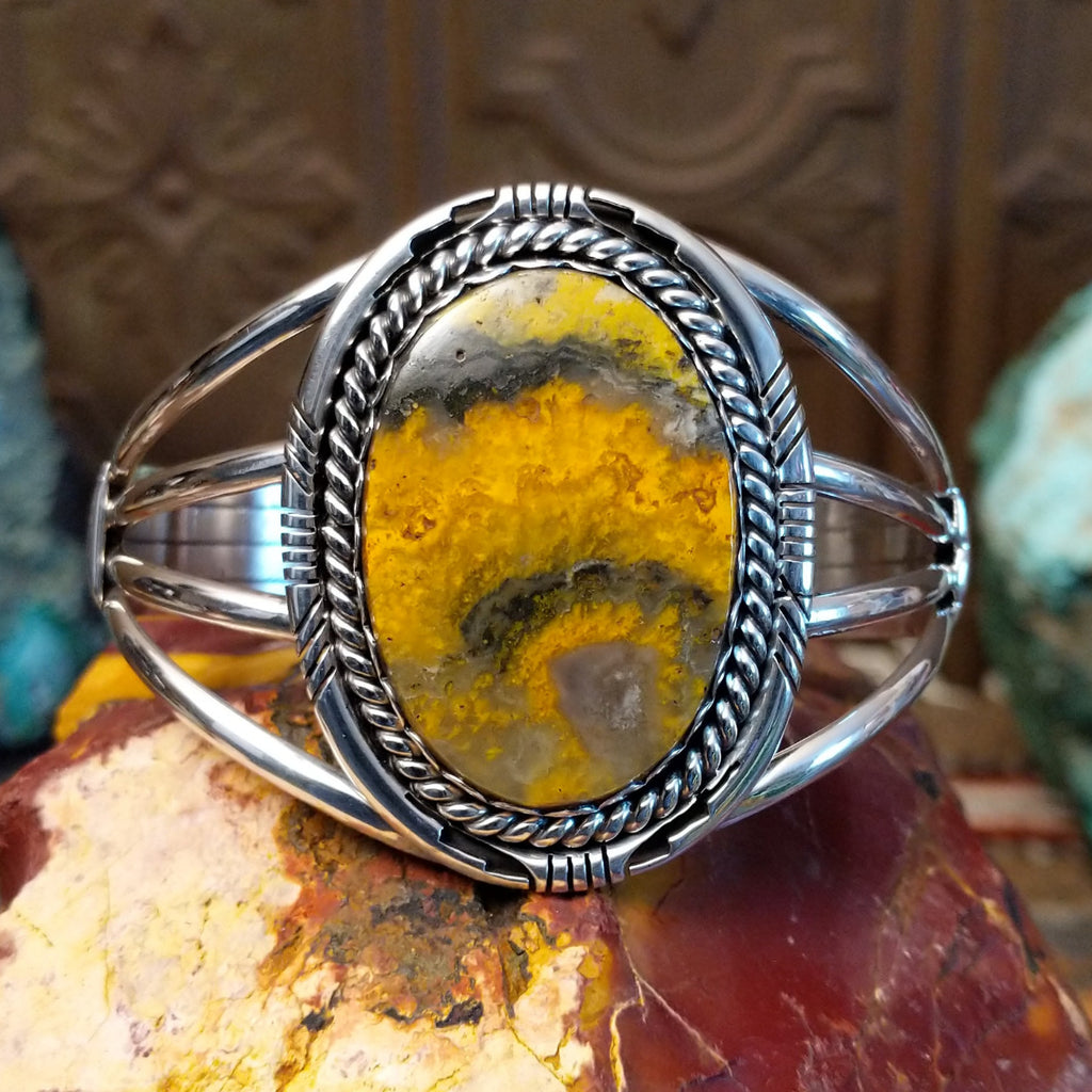 Large bumblebee jasper framed by twisted rope accent and layered band of the cuff.