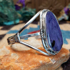 Large charoite cuff by Richard Kee, featuring a bold purple charoite stone with natural swirling patterns and handcrafted Southwestern-inspired metalwork.  Side view.