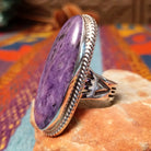 Large Charoite Ring by Sharon Francisco featuring an elongated purple charoite stone with natural swirling patterns, framed by twisted rope detailing and set in Sterling Silver; side view.