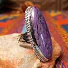 Large Charoite Ring by Sharon Francisco featuring an elongated purple charoite stone with natural swirling patterns, framed by twisted rope detailing and set in Sterling Silver; side view.