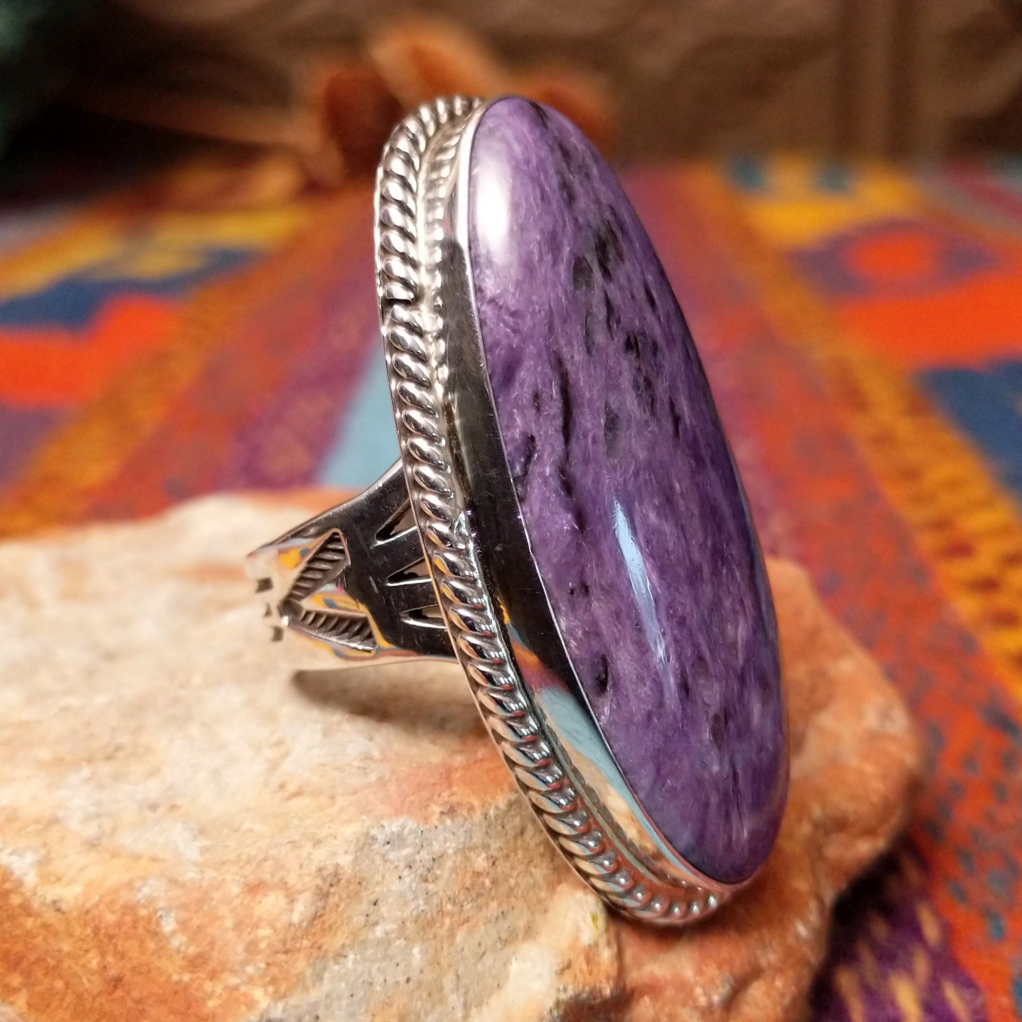 Large Charoite Ring by Sharon Francisco featuring an elongated purple charoite stone with natural swirling patterns, framed by twisted rope detailing and set in Sterling Silver; side view.