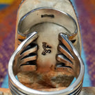 Large Charoite Ring by Sharon Francisco featuring an elongated purple charoite stone with natural swirling patterns, framed by twisted rope detailing and set in Sterling Silver; artisan and Sterling Silver stamp.