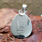 The back of the pendant features both artisans stamped signatures.