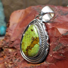 Sterling silver pendant with gaspeite framed by twisted rope and intricately detailed bezel.