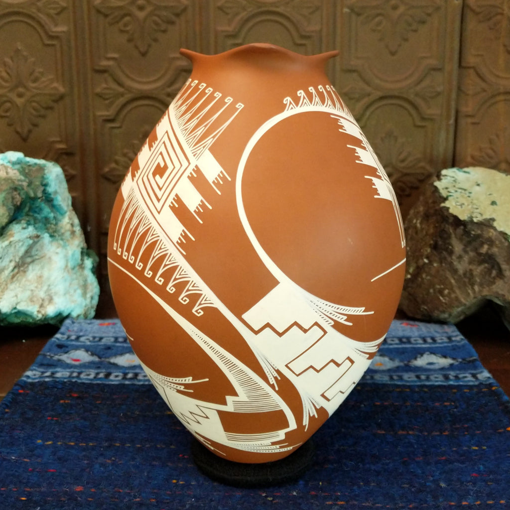 Terracotta clay with intricate white geometric patterns.