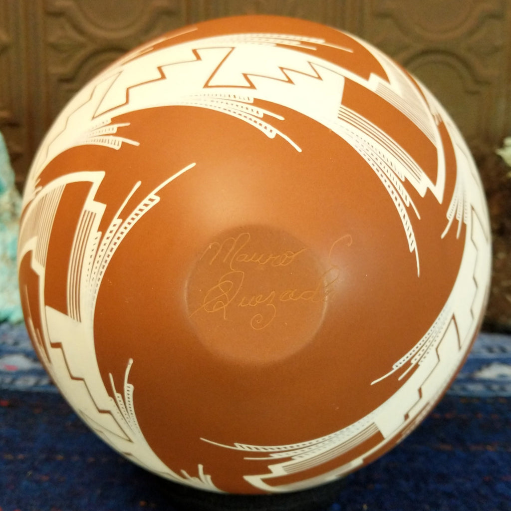The artisan's etched signature is on the base of the pot.