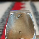 Large multistone inlay ring by Wilbert Grey featuring a rectangular geometric design of orange-red shell, turquoise, and deep blue stones with silver channel accents in a wide polished silver band; artisan and Sterling Silver stamp.
