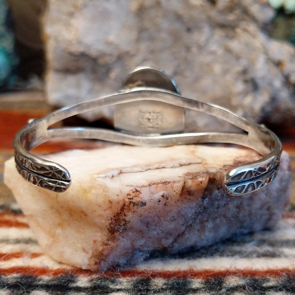 Sterling silver band with stamped designs.
