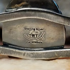 Close-up of the artisan's stamped signature.
