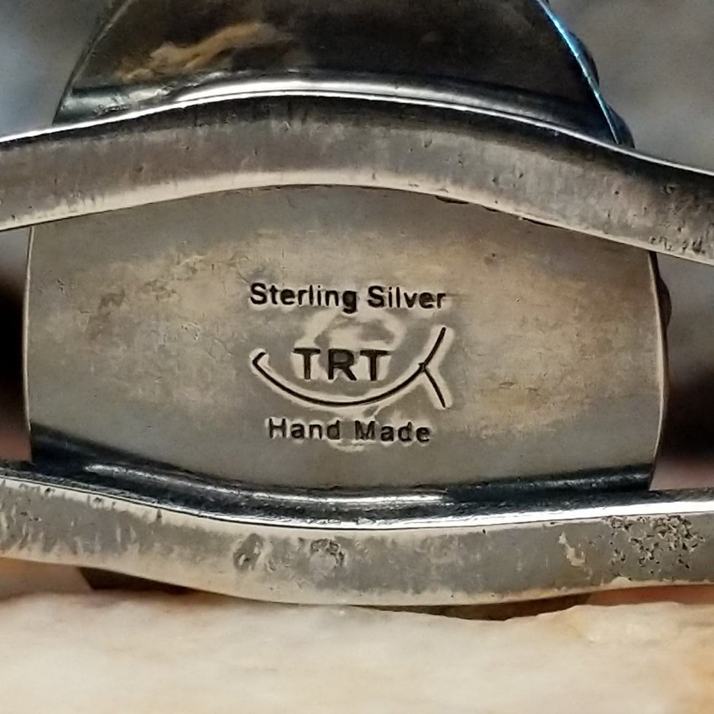 Close-up of the artisan's stamped signature.