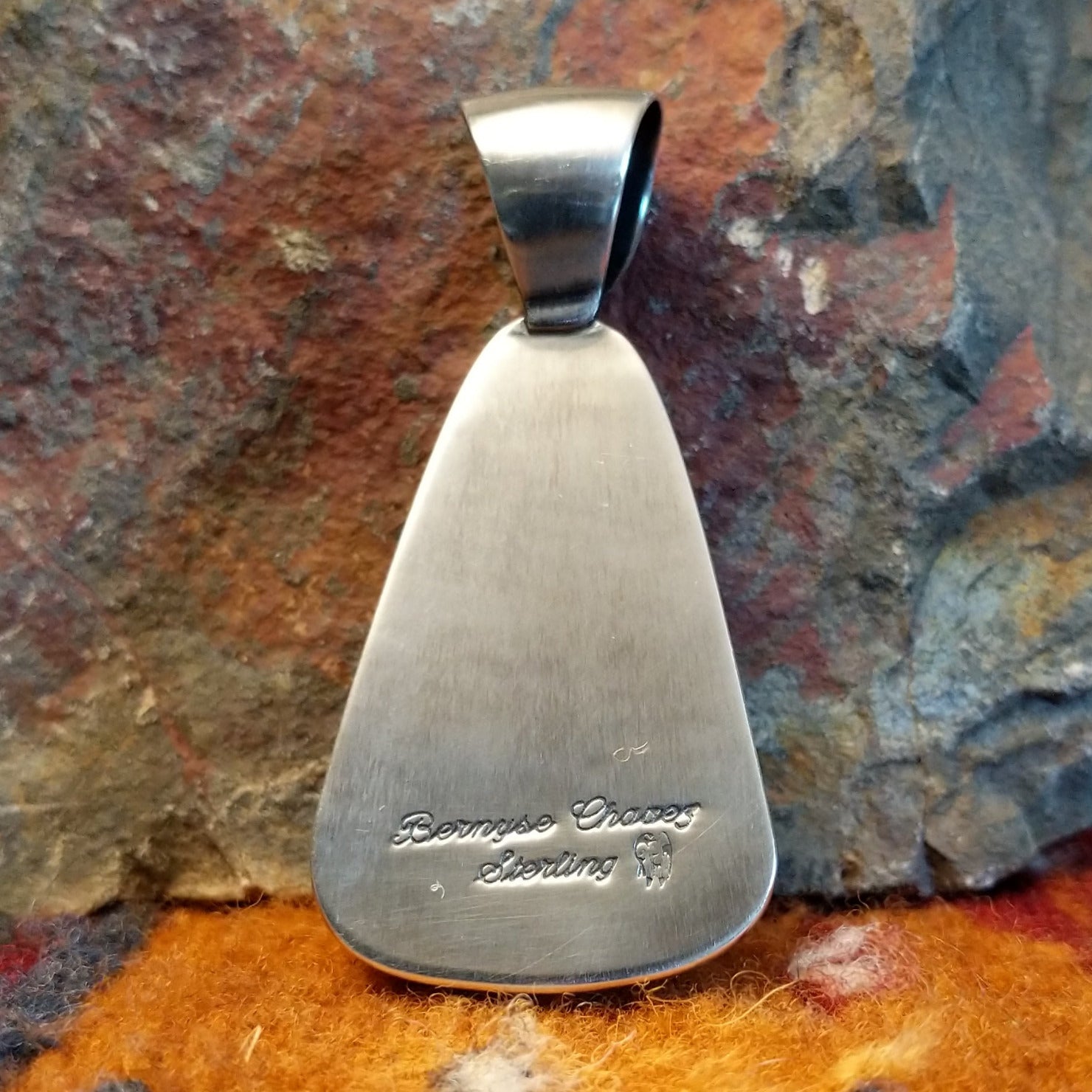 Close-up of the artisan's stamped signature.