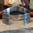 Cuff with a intricately detailed band.