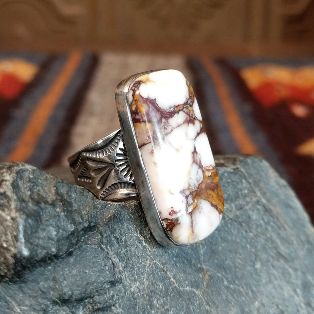 Wild horse stone with brown matrix set in a polished bezel and intricate stamps along the band.