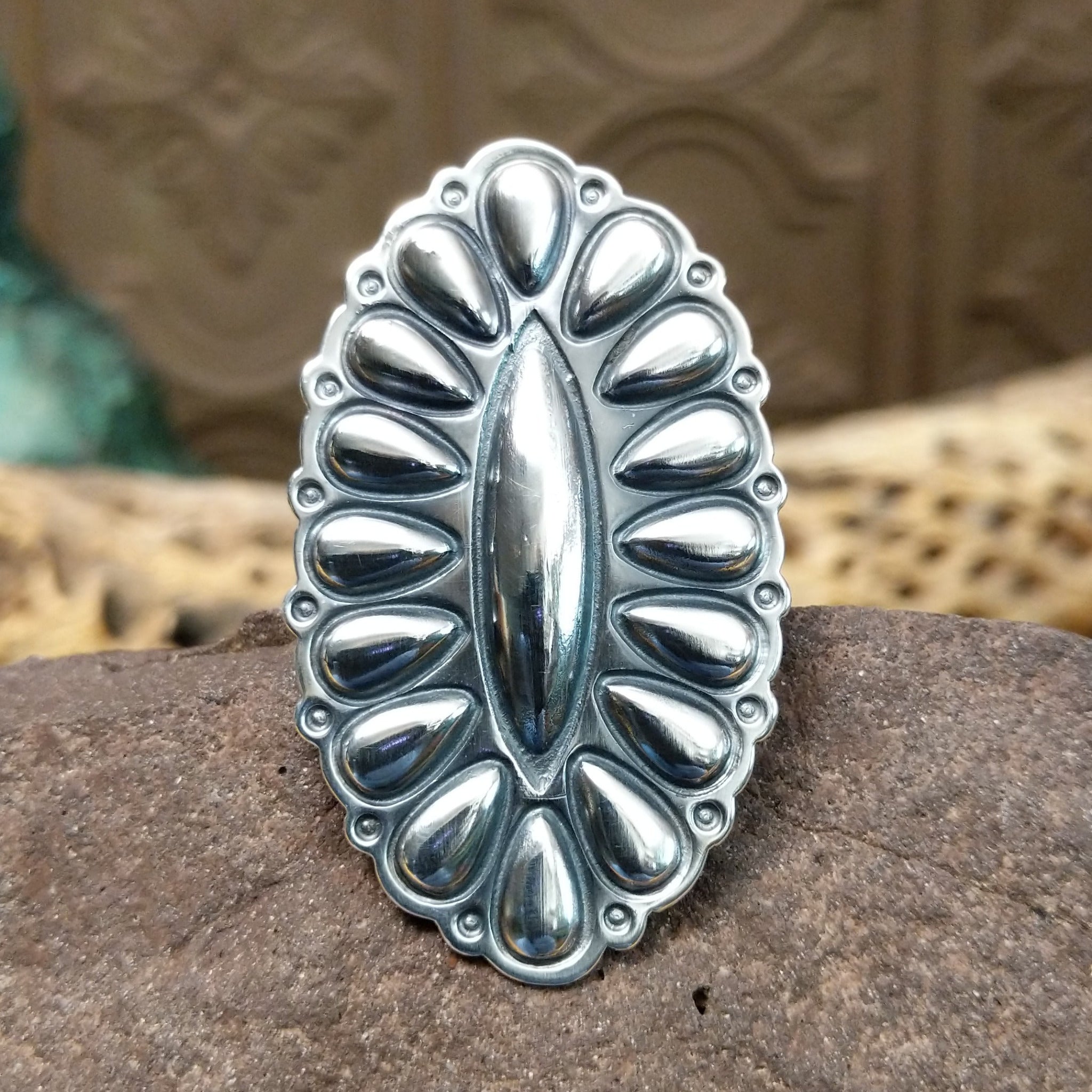 Large stamped sterling silver ring by Charles Johnson, featuring intricate hand-stamped patterns on a bold polished silver band with traditional Southwestern-inspired craftsmanship.