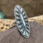 Large stamped sterling silver ring by Charles Johnson, featuring intricate hand-stamped patterns on a bold polished silver band with traditional Southwestern-inspired craftsmanship.  Side view.