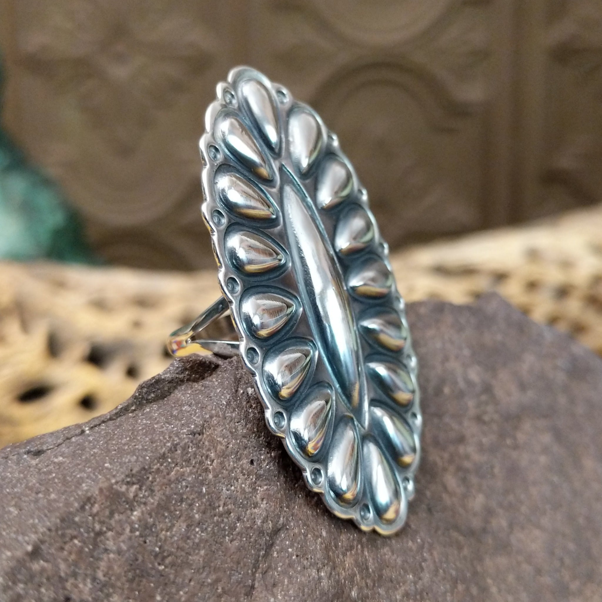 Large stamped sterling silver ring by Charles Johnson, featuring intricate hand-stamped patterns on a bold polished silver band with traditional Southwestern-inspired craftsmanship.  Side view.