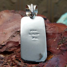 The back features the artisan's stamped signature.
