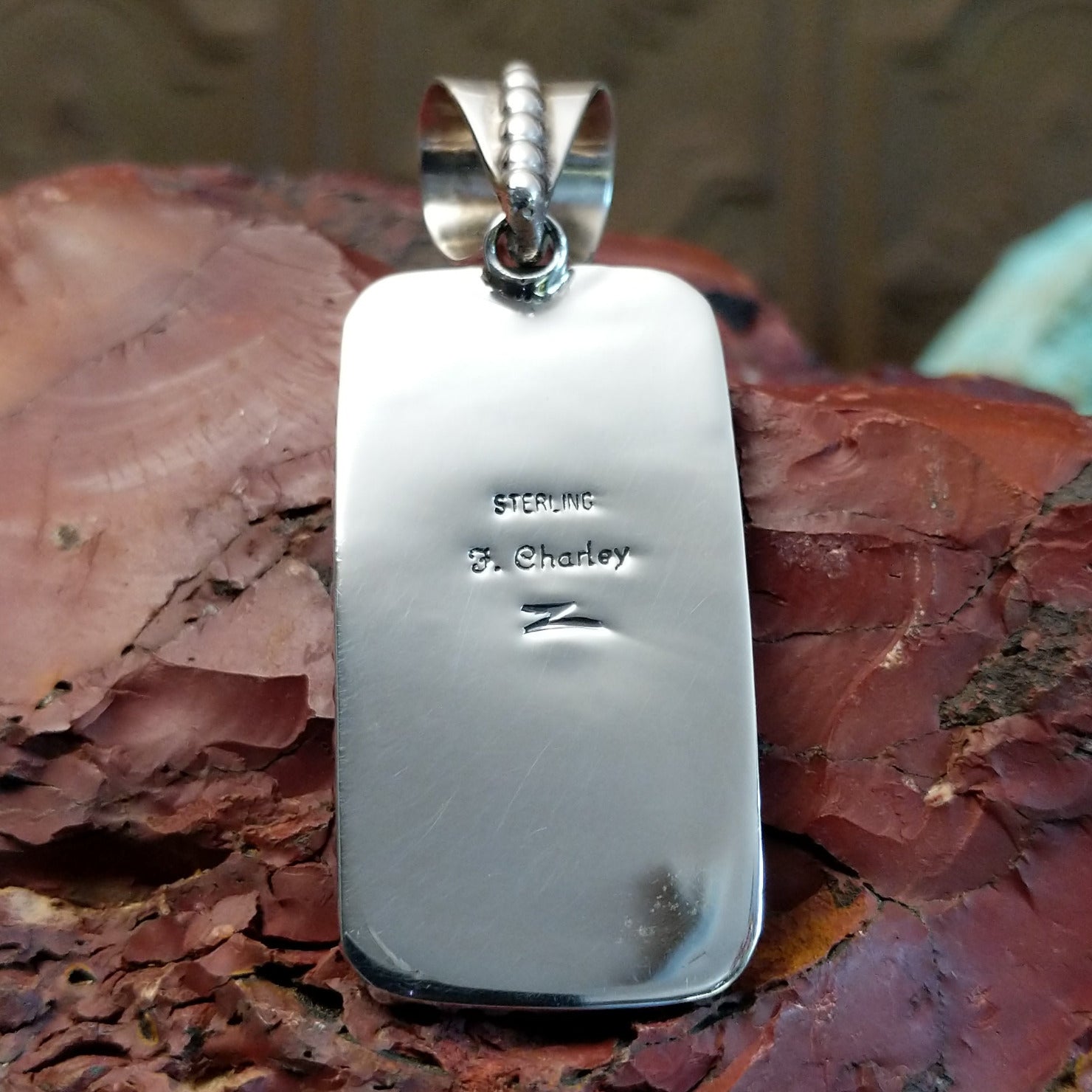 The back features the artisan's stamped signature.