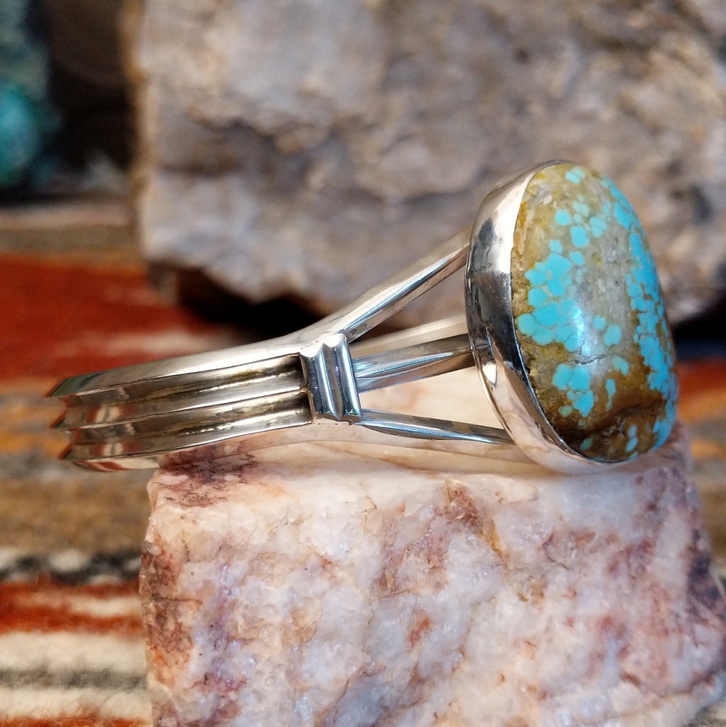 Sterling silver cuff with a large turquoise stone set in the bezel.
