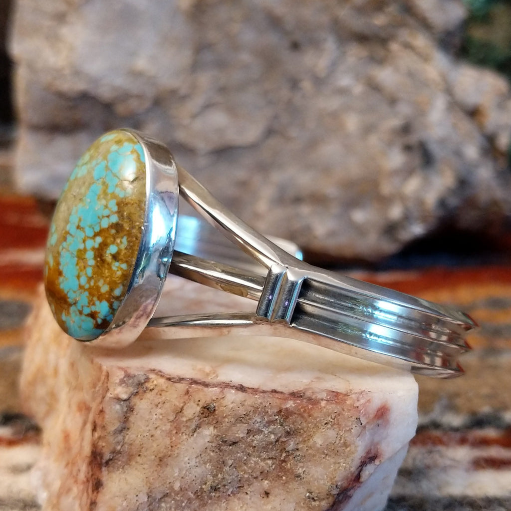 Sterling silver cuff with a large turquoise stone set in the bezel.