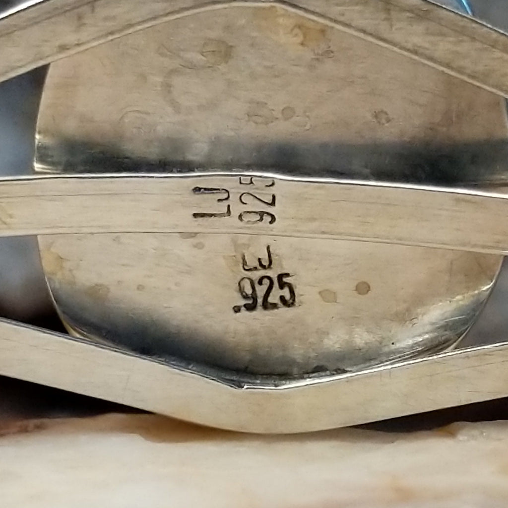 Close-up of the artisan's stamped initials.