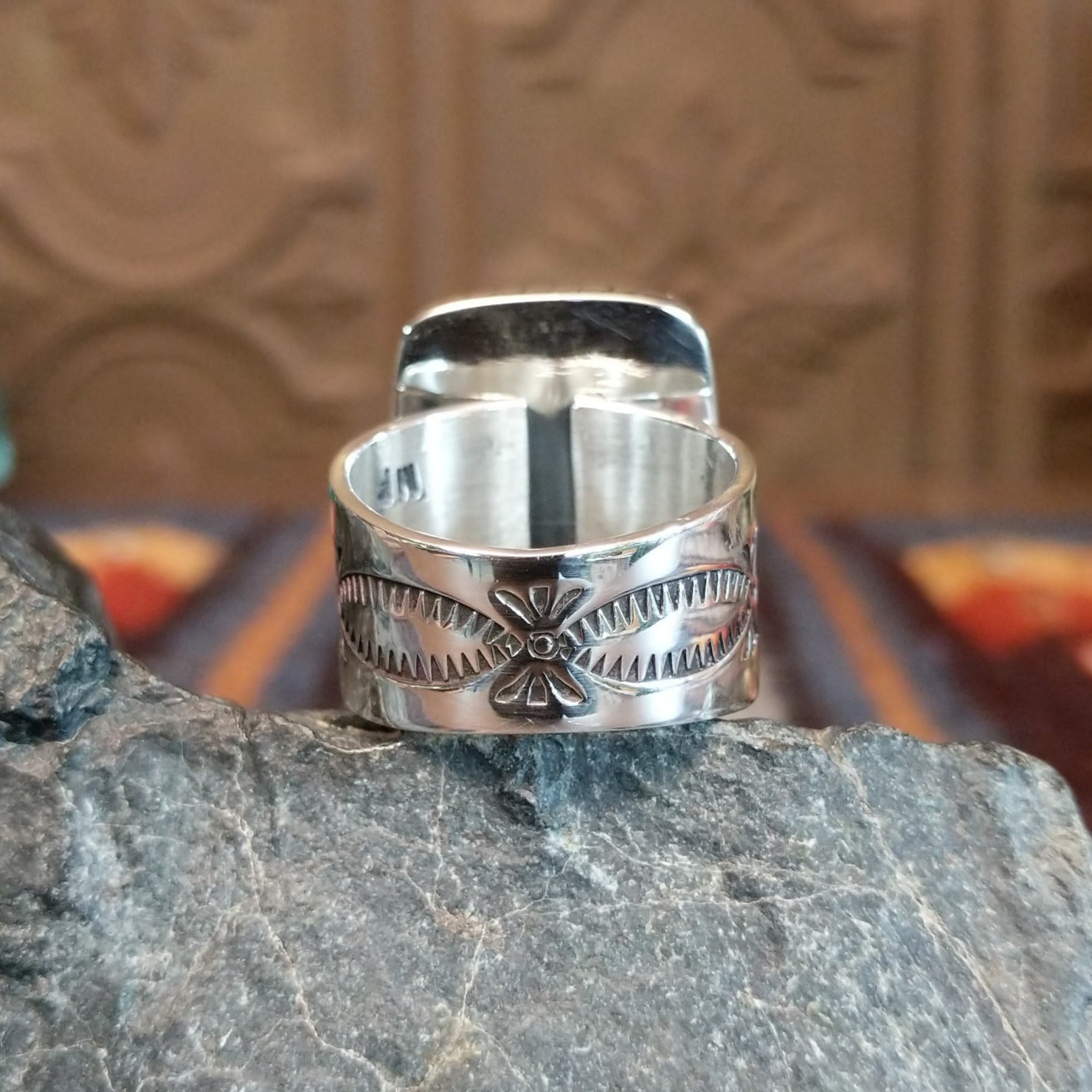 The intricately stamped band of the ring.