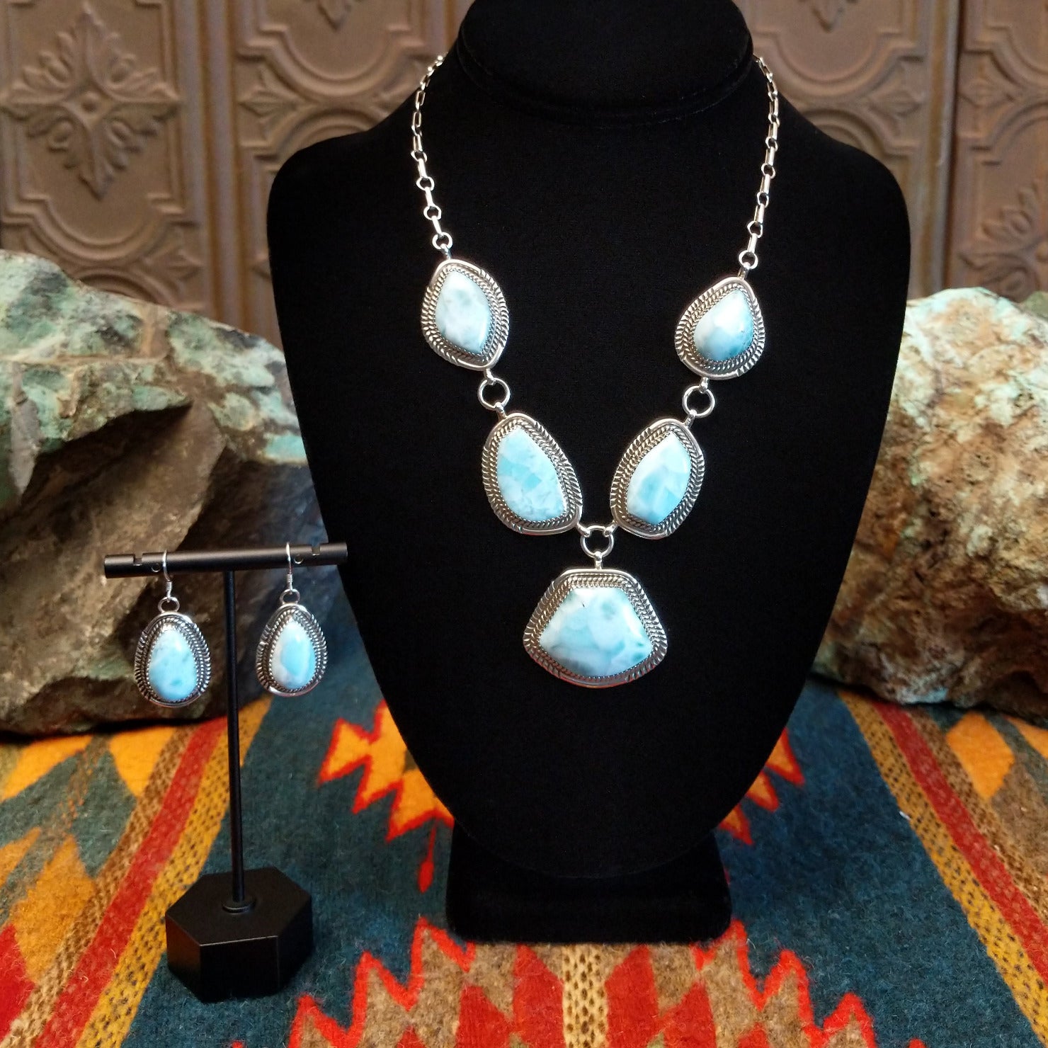 Sterling silver necklace and earrings set with larimar set in geometric bezels, framed by twisted rope and stamped accents.