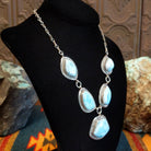 Sterling silver necklace with larimar set in geometric bezels, framed by twisted rope and stamped accents.