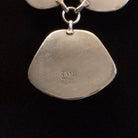 Close-up of the artisan's stamped signature.