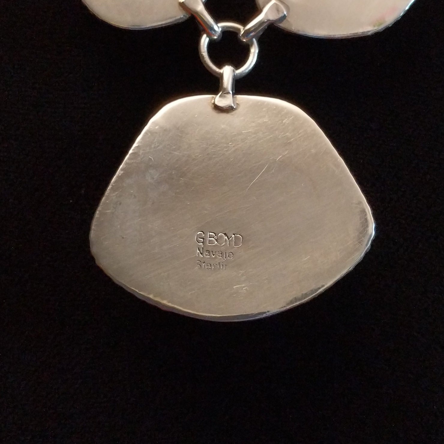 Close-up of the artisan's stamped signature.