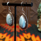 Sterling silver earrings with larimar set in geometric bezels, framed by twisted rope and stamped accents.